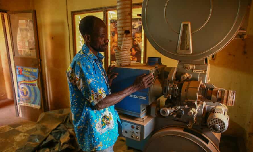 Projectionist Antoine Oudraogo next to an old film projector at the Cinéma Somgande during the festival.