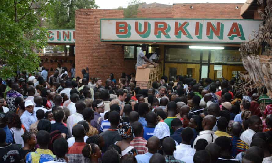 People wait outside Ciné Burkina in Ouagadougou.