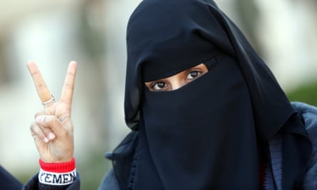 A female Yemeni student living in Iran flashes the victory sign during a protest against Saudi-led airstrikes.