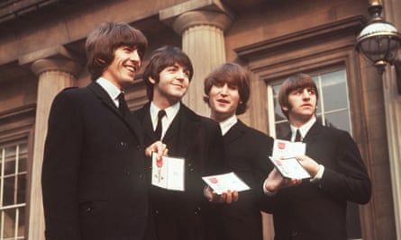 The Beatles in the forecourt of Buckingham Palace after receiving their MBE awards.