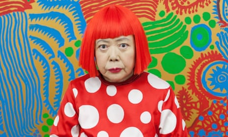 Yayoi Kusama sits in front of one of her newly finished paintings in her studio.
