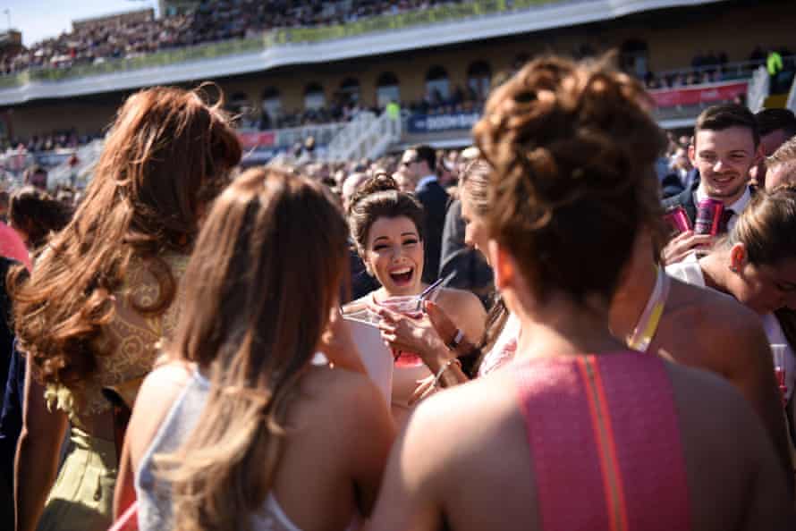 Racegoers laugh on the final day of the Grand National Festival horse race meeting at Aintree Racecourse in Liverpool.