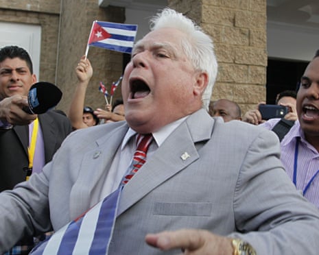 A man shouts slogans against pro-government supporters from Cuba and Venezuela