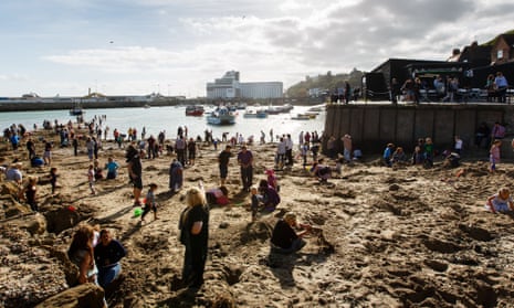 People digging on Folkestone Harbour beach 