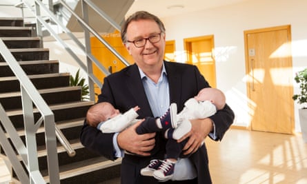 Tim Child, the medical director of the Oxford Fertility Unit, holding Freddy and Olly.