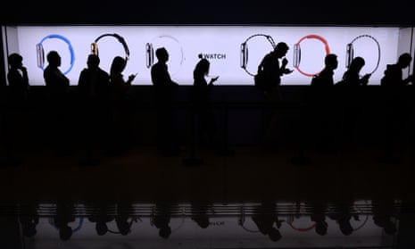 People wait in a queue to test out the new Apple Watch at a store in Hong Kong on April 10, 2015. Apple says its first wearable device will connect wirelessly to a user's iPhone and will be the interface for messaging, calls and apps, especially ones geared toward health and fitness.