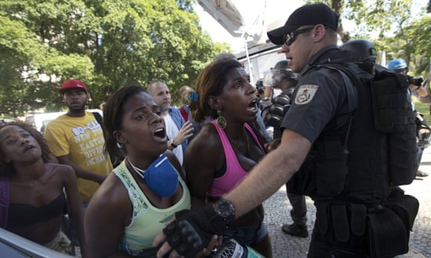 Women are held back by police after their friend was detained during their eviction from a building they invaded about a week ago in the Flamengo neighborhood of Rio de Janeiro. Police dislodged squatters from the building slated for use as a luxury hotel for the 2016 Olympics.