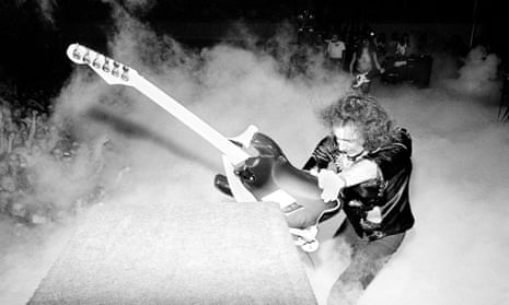 Ritchie Blackmore, guitarist with Deep Purple, smashing guitar against speakers on US tour. 1974