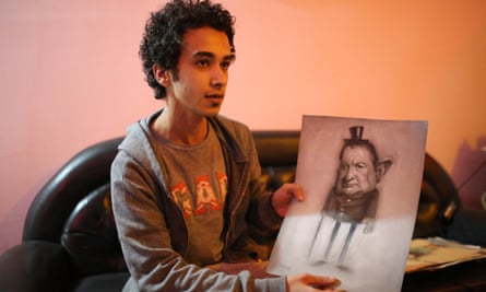 Hussein Adel with one of his drawings