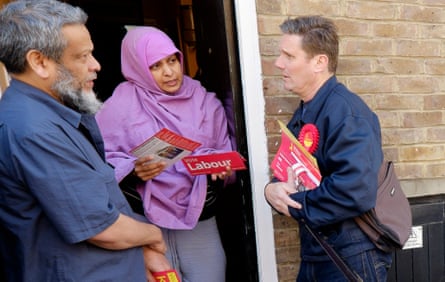 Keir Starmer, right, talks to potential voters