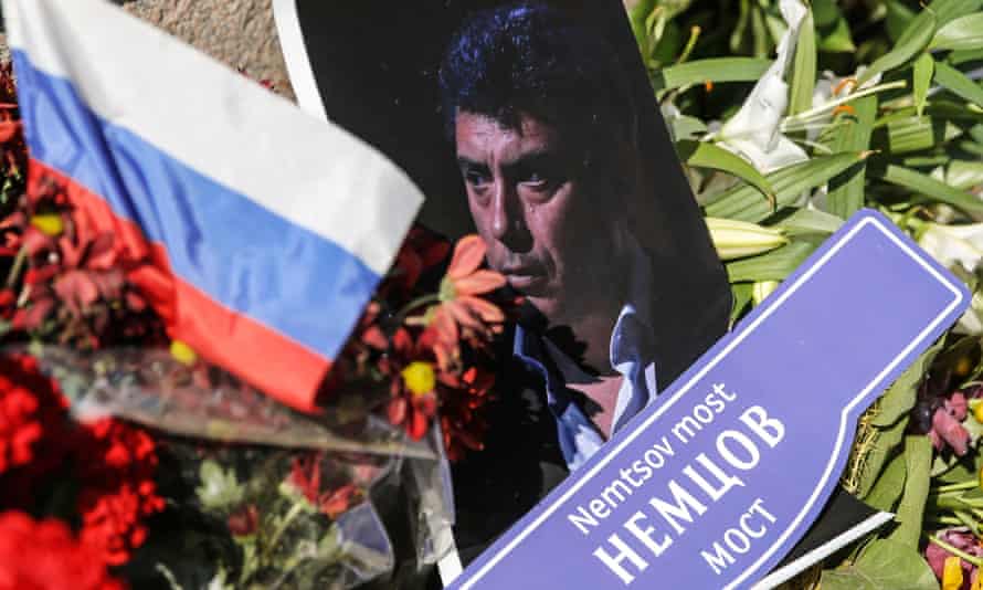 A photograph and floral tributes at the site of Boris Nemtsov's murder in central Moscow.