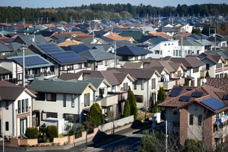 Solar panels sit on house roofs in Inzai, Chiba Prefecture, Japan, on December 9, 2014. Japans recession was deeper than initially estimated as company investment unexpectedly shrank, a blow to Prime Minister Shinzo Abe as he campaigns for re-election on his economic credentials.