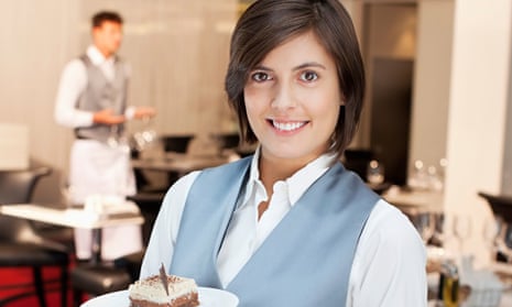 Portrait of smiling waitress holding desserts in restaurant. Image shot 2012. Exact date unknown.