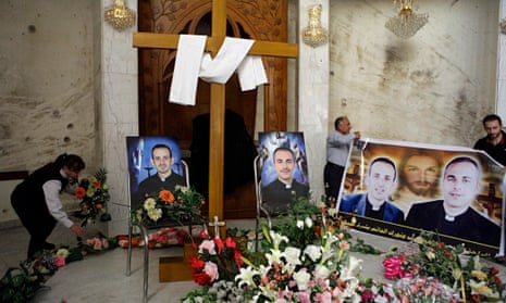 Photographs of slain Iraqi priests at a church in Baghdad