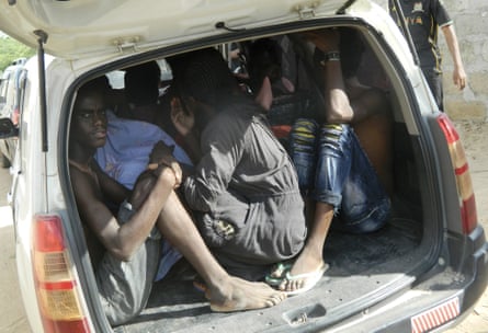 Students of the Garissa University College take shelter in a vehicle after fleeing the attack.