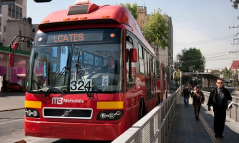 A Metrobus pulls up to a station in Mexico City.