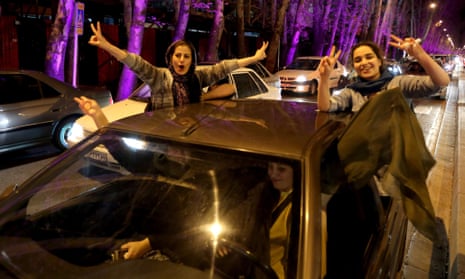 Women flash the "V for Victory" sign as they celebrate on Valiasr street in northern Tehran after the announcement of an agreement on Iran nuclear talks.