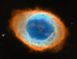 The Hubble’s image of the Ring Nebula, the glowing shroud around a dying Sun-like star. The pictures Hubble was able to capture allowed astronomers to construct a precise three-dimensional model of the glowing gas shroud, called a planetary nebula. 
