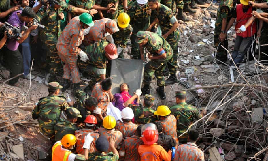 Rescue workers rescue a woman from the rubble of the Rana Plaza building 17 days after the building collapsed in Savar May 10, 2013.