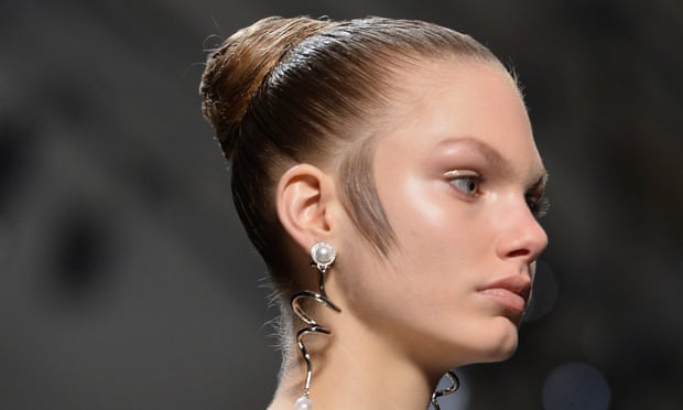 Hair styled flat to the side of a model's face on the  Balenciaga runway.