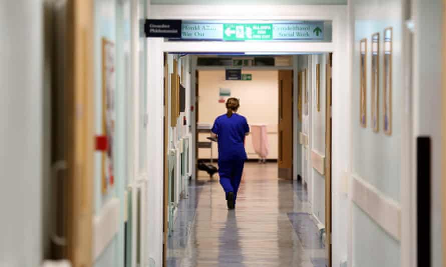 A nurse walks the hospital corridors
