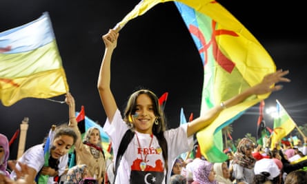 A girl waves an Amazigh flag at a rally in September 2011 in Tripoli calling for the recognition of the Amazigh language and culture.