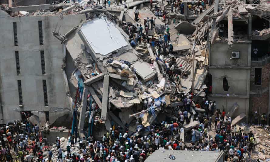 People rescue garment workers trapped under rubble at the Rana Plaza building.