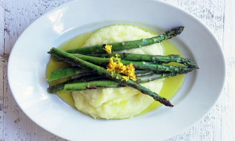 Asparagus spears with a grating of lemon zest, lying across mashed potato