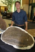 Evan Saitta with one of the Stegosaurus back plates.