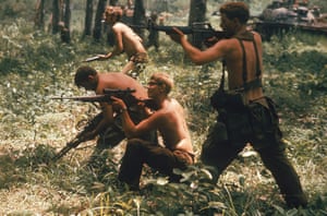 1970:   Half-dressed US soldiers of the 9th Infantry fire on enemy troops somewhere along the South Vietnamese-Cambodian border