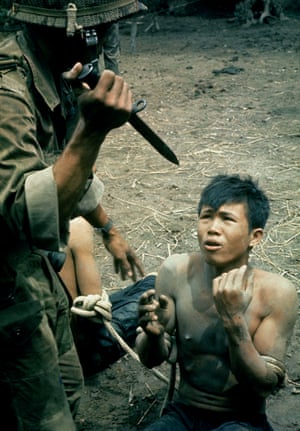 1962 A bayonet-wielding South Vietnamese paratrooper threatens a captured Vietcong suspect during an interrogation

• All photographs by Larry Burrows/Time & Life pictures/Getty unless stated