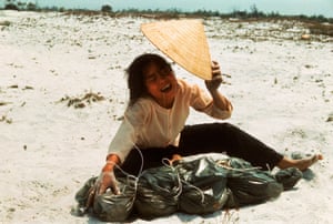 1969 A grieving widow cries over a body bag containing remains of her husband which was found in a mass grave containing civilians killed by Viet Cong during the Tet offensive which took place the previous year