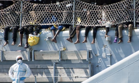 Migrants wait to disembark from an Italian navy ship in Salerno. Theresa May and Philip Hammond believe such rescue operations create a ‘pull factor’ and lead to more deaths by encouraging migrants to risk the dangerous sea crossing. 