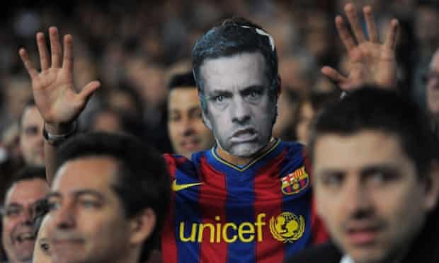 A Barcelona fan with a cardboard mask of José Mourinho.