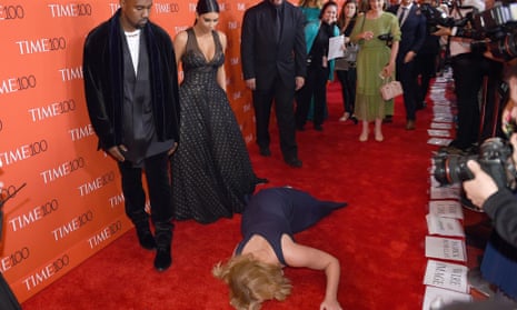 Amy Schumer prostrates herself in front of an unimpressed Kim Kardashian and Kanye West.