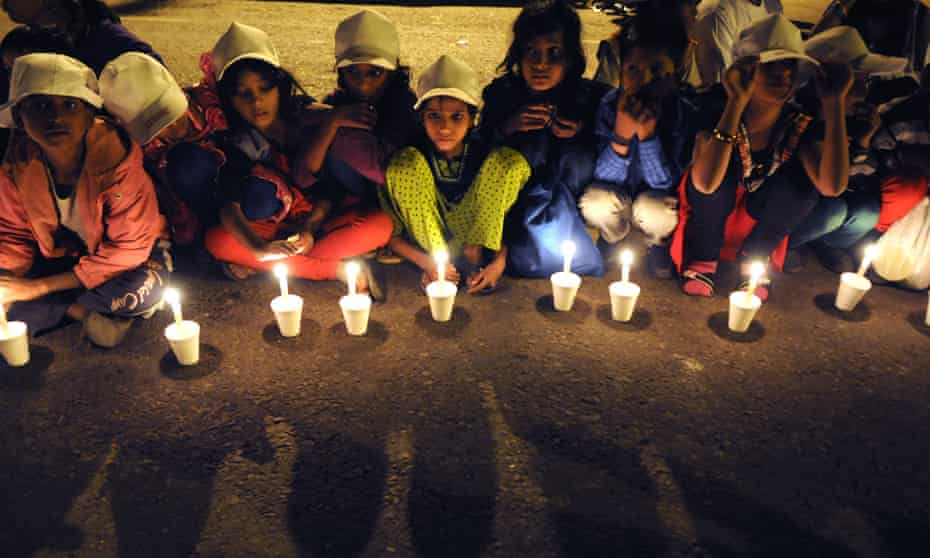 Children in New Delhi take part in a candlelit vigil to end child slavery in November 2014. An estimated 135,000 children are trafficked in India annually. 