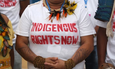 indigenous woman wears a tshirt calling for land rights