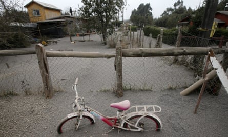 A child's bicycle shows the depth of ash from the Calbuco volcano blanketing the ground.