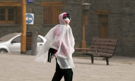 A woman walks in a street covered in ash in Bariloche, Argentina.