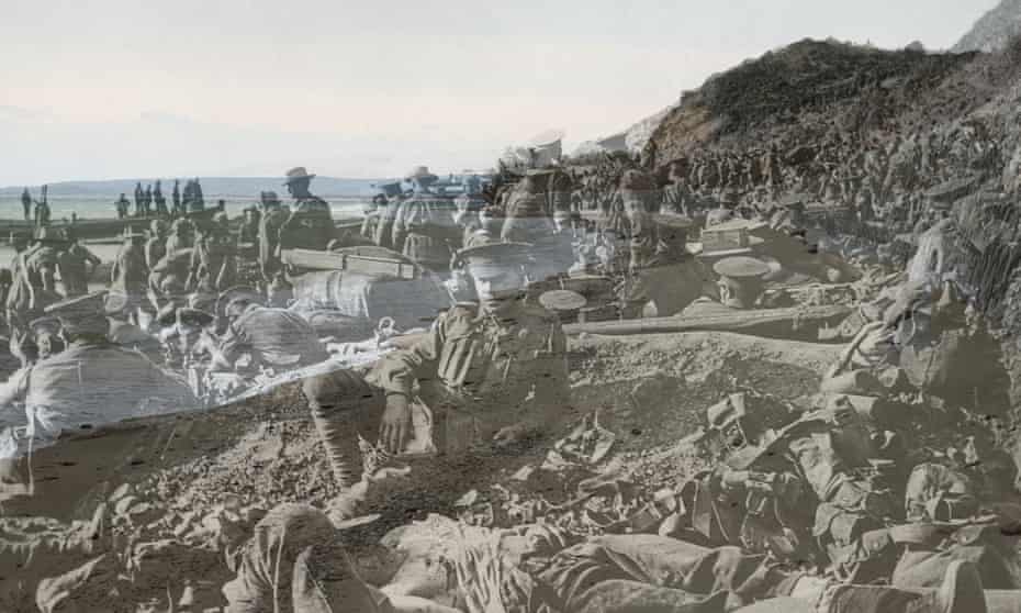25 April 1915: An Australian soldier lies wounded in the foreground, as hundreds of other troops move among the dead and wounded on the beach at Anzac Cove.