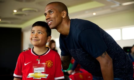 Ashley Young with a young Manchester United supporter on the club's Dream Day, held at the Aon Training Complex.