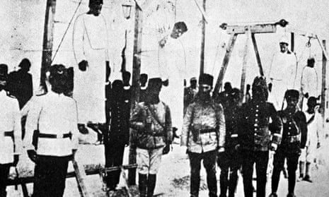 Ottoman soldiers posing in front of hanged Armenians, 1915. Photograph: AFP/Getty Images