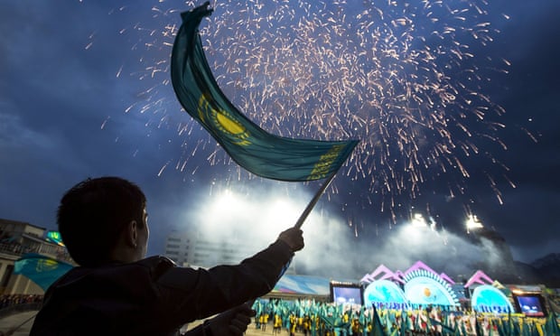 A man waves a national flag during a campaign rally for Nursultan Nazarbayev at a stadium in Almaty.