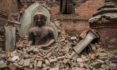 A Buddha statue is surrounded by debris from a collapsed temple in the UNESCO world heritage site of Bhaktapur on April 26, 2015 in Bhaktapur, Nepal.