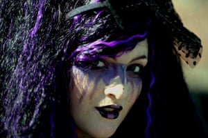 Shannon McHugh dressed as a Gothic character poses for pictures while attending the Goth festival in Whitby, North Yorkshire