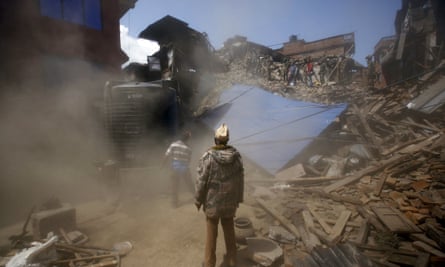 A damaged house is brought down during the search for trapped victims following Saturday’s earthquake in Bhaktapur, Nepal.