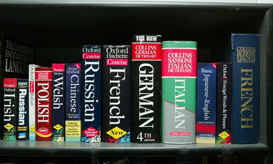 Many language dictionaries on a shelf