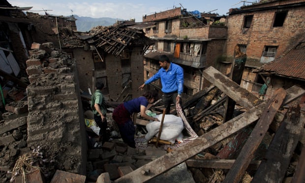A Nepalese family collects belongings from their home destroyed in Saturday's earthquake, in Bhaktapur on the outskirts of Kathmandu.