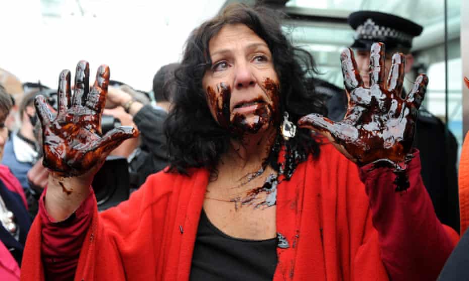 A protester daubs herself with oil as she tries to gain access to the BP AGM in London on 14 April.