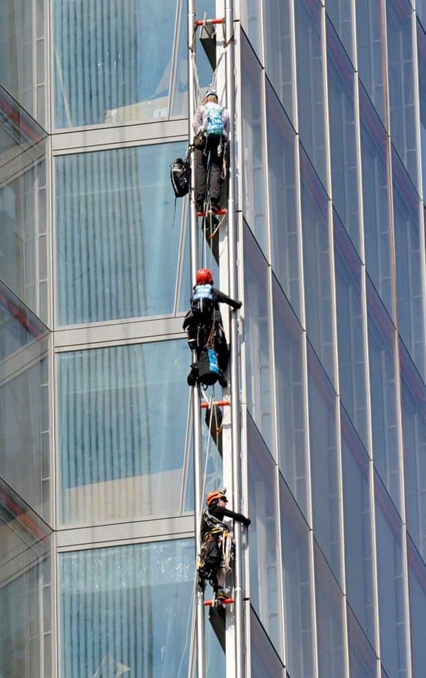 Three of the Greenpeace activists mid-ascent.